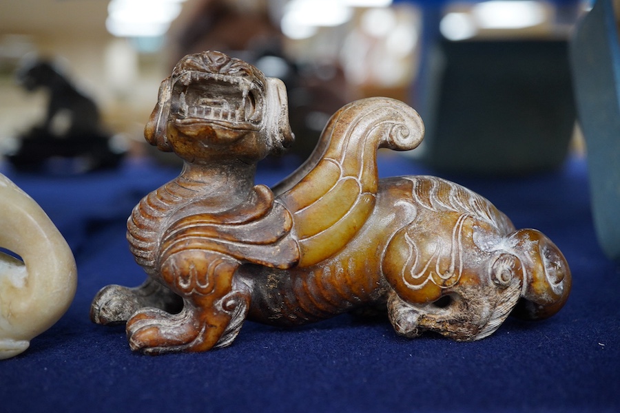 Three Chinese archaistic jade carvings of a winged mythical beast, a duck and a horned seated beast, one stand, largest 13cm wide, 7.5cm high. Condition - good.